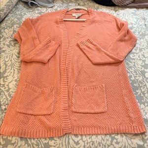 Adorable pink colored cardigan with pockets